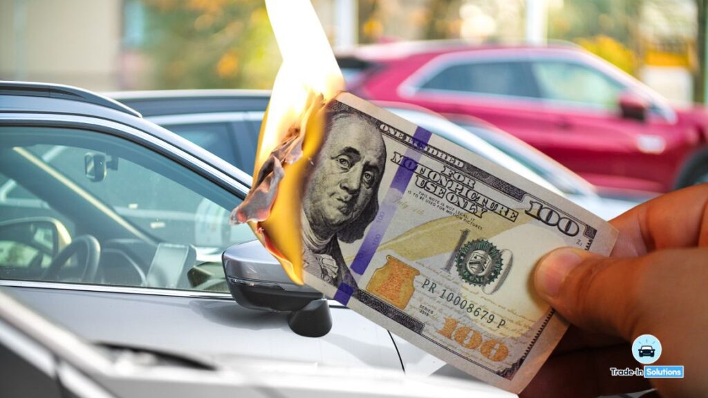 A person holding up a $ 1 0 bill in front of the windshield wiper.